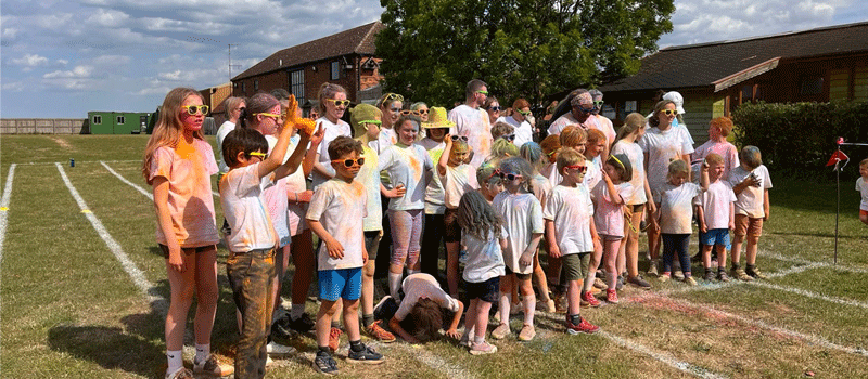 Children and parents lining up covered in paint powder